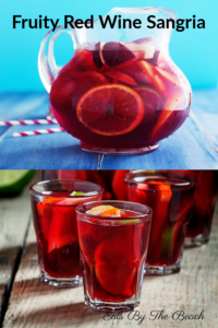 Pitcher of red wine sangria with glasses of sangria and sliced fruit