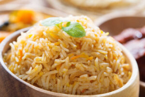 Wooden bowl with Basic Biryani Rice. Side view close up