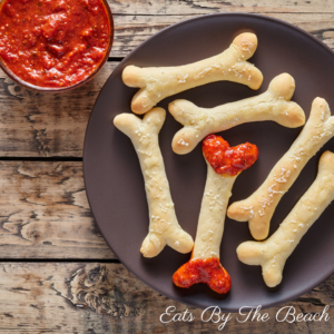 Bones and blood, a Halloween appetizer of breadsticks shaped like bones and served with a side of blood, which is marinara sauce.