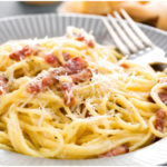 Plate of pasta carbonara-spaghetti in a creamy, egg and parmesan sauce with pancetta. An easy pasta recipe.
