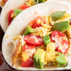 Vegetarian Migas tacos with eggs, onion, jalapeno, fried corn tortilla pieces, and cheese. A Tex-Mex recipe.