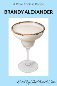 A beautiful cocktail glass with a retro cocktail. This Brandy Alexander is made with brandy, dark creme de cacao, and heavy cream. Garnished with a rim of cocoa powder and nutmeg, this is a perfect after dinner drink.