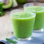 Glass of Sweet Green Smoothie with apple, kiwi, spinach, mint, avocado, and almond milk. This is a quick breakfast option by Eats By The Beach.