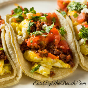Spicy breakfast tacos with Mexican chorizo, scrambled eggs, tomatoes, and cilantro.