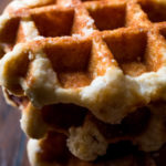 Plate of crunchy cornbread waffles. Cornbread that is baked in a waffle iron made by EatsByTheBeach.Com