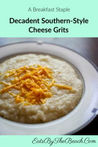A bowl of decadent Southern-Style Cheese grits - creamy stoneground grits are cooked with broth, milk, onion and garlic powders, and shredded cheddar cheese.