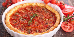 Easy Southern Tomato Tart with sliced beefsteak tomatoes, pimento cheese, and homemade herbed olive oil in a flaky pie crust.