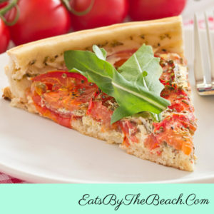 Easy Southern Tomato Tart with sliced beefsteak tomatoes, pimento cheese, and homemade herbed olive oil in a flaky pie crust.