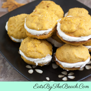 Pumpkin Whoopie Pies - 2 bites sized pumpkin spiced cakes sandwiched with a fluffy cream cheese filling.