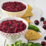 Bowls of Fresh Cranberry Salsa - a twist on a traditional Thanksgiving favorite. Fresh cranberries, jalapenos, ginger, onions, and cilantro is a sweet and spicy treat.