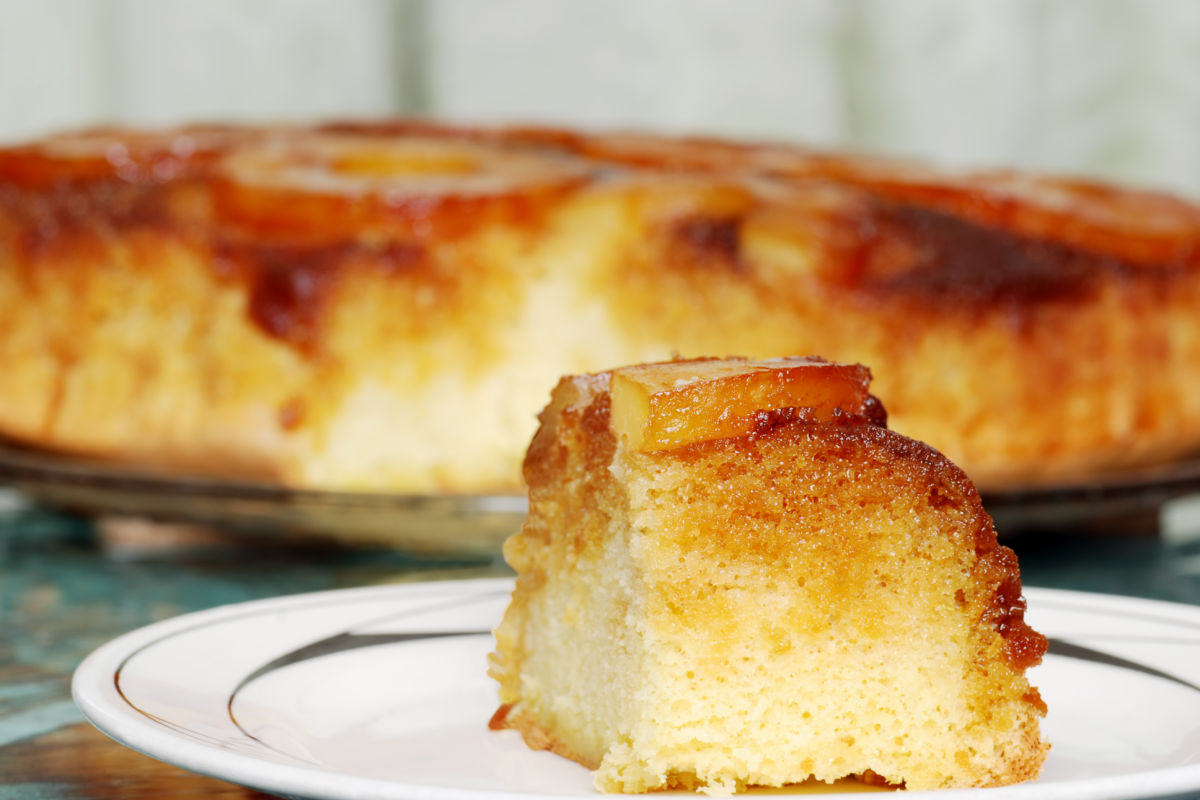 Slice ofhomemade Pineapple Upside Down Cake on a white plate.