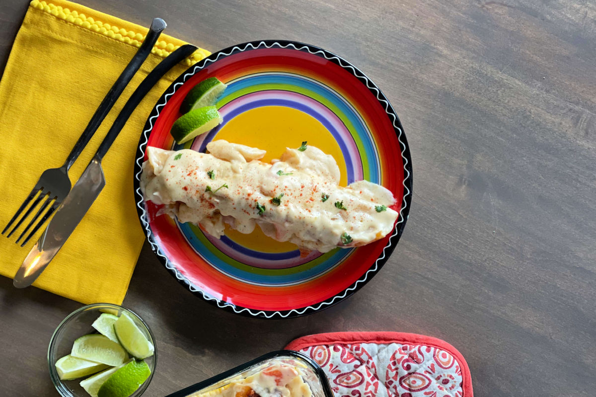 A pan of creamy, Seafood Enchiladas - a Chi Chi's copycat recipe - shrimp and crab in a creamy, cheesy sauce and baked to golden perfection.