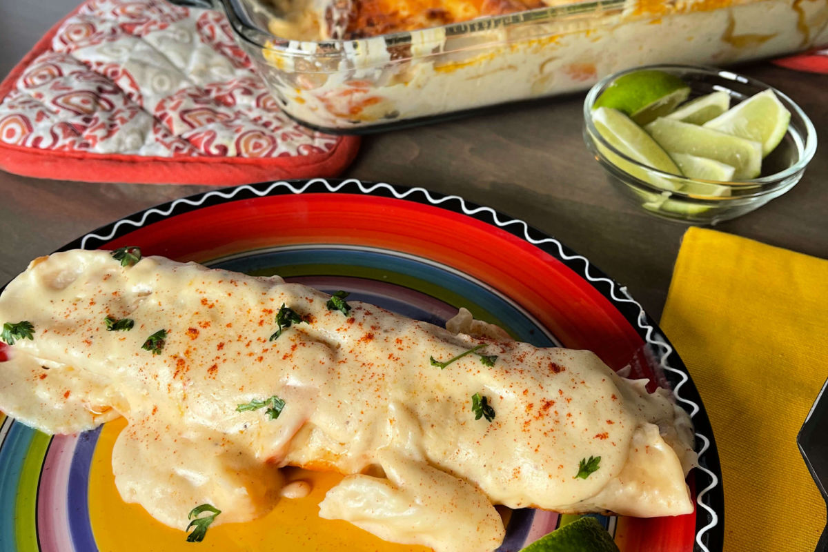 A pan of creamy, Seafood Enchiladas - a Chi Chi's copycat recipe - shrimp and crab in a creamy, cheesy sauce and baked to golden perfection.