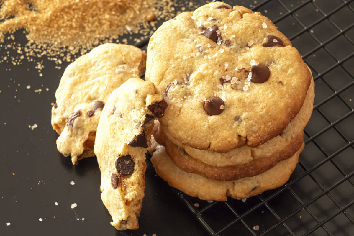 Slate platter of buttery, salted caramel chocolate chip cookies