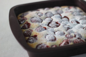 Pan of Fresh Strawberry Clafoutis with fresh berries baked in an almond-scented custard.