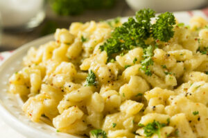 Bowl of homemade Parslied German Spaetzle garnished with chopped parsley.