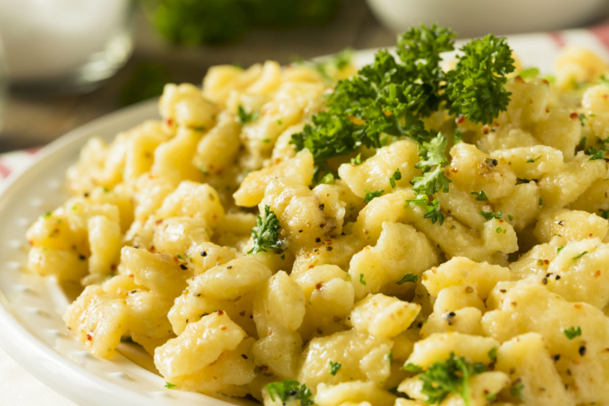 Bowl of homemade Parslied German Spaetzle garnished with chopped parsley.