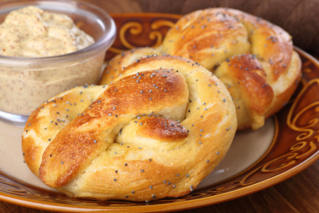 Plate with Philadelphia Soft Pretzels and mustard dipping sauce.