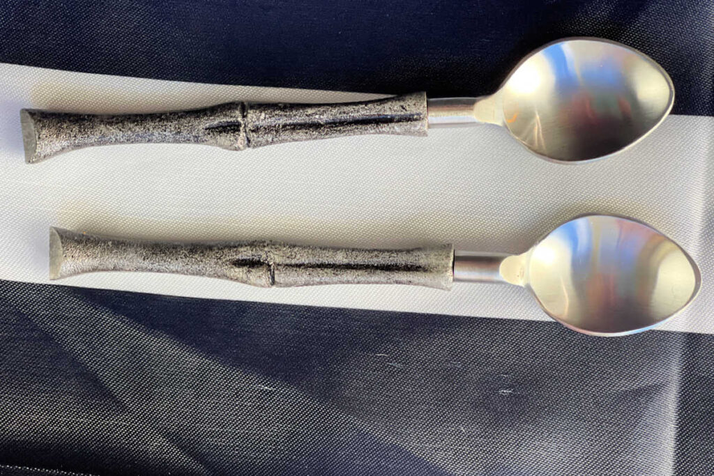 Overhead view of 2 spoons with handles shaped like bones.