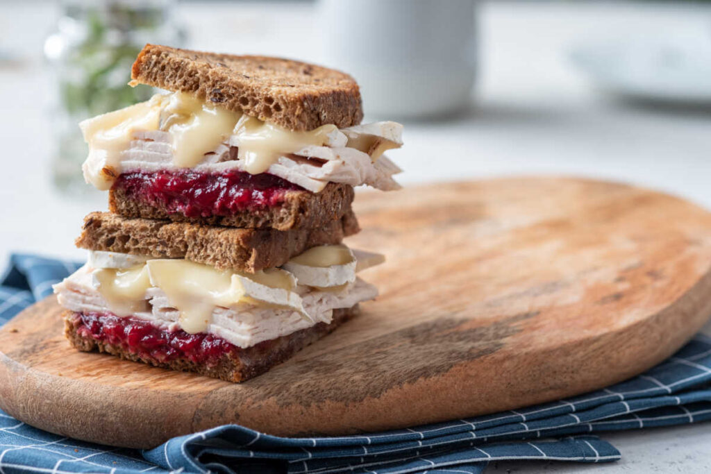 Homemade Baked Turkey and Brie Sandwich with a homemade mayonnaise and cranberry sauce spread.